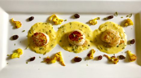 Sea Scallops with Saffron Cream Sauce, Turmeric-Dusted Cauliflower, and Buttered Raisins